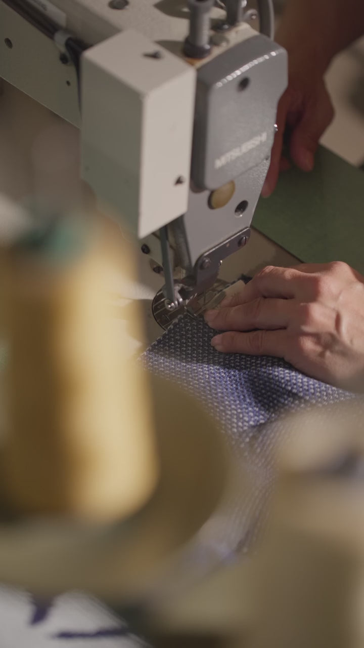 Stitching on Biquette tags on each knit
